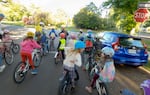 Abernethy Elementary School students approach an intersection at the Ladd Circle on a "bike bus" group ride to school on May 21, 2025.