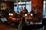 Patrons pack inside Butter Notes Cafe on June 21 to listen to sax-led quartet, Society Red.