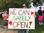 Parents of school children at a demonstration pushing for safe reopening of schools for some students