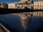 The dome of the U.S. Capitol building is visible in a reflection on Capitol Hill in Washington, D.C., Jan. 23, 2023.