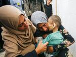 Fatma Hijazi holds the lifeless body of her 10-year-old child, Mustafa Hijazi, who died due to malnutrition and lack of medication in Deir al-Balah, Gaza. The photo is from June 14.