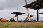 Crews installing a set of solar arrays at Our Table Cooperative farm in Sherwood, Ore., on Sept. 12, 2024. The panels will produce enough energy to power the on-farm grocery store and freezers.