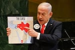 Israeli Prime Minister Benjamin Netanyahu holds up a map Friday while speaking at the 80th session of the United Nations General Assembly, at U.N. headquarters.