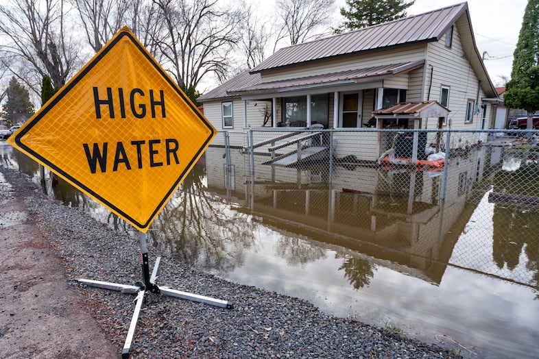 A warning sign in the flooded area in Burns, Ore., March 30, 2025. Accelerated snowmelt from the region has triggered widespread flooding in the area.