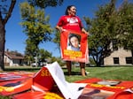 Melissa Lonebear holds a banner with a picture of Kaysera Stops Pretty Places on it during a rally in support of the Missing and Murdered Indigenous People movement at the Big Horn County Building in Hardin, Mont., on Aug. 29, 2023.
