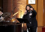 Marilyn Keller, a leading force behind Measure 114, sings at the election watch party held at Augustana Lutheran Church in Portland, Ore., Nov. 8, 2022.