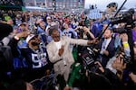 Miami quarterback Cam Ward takes a selfie with fans after being chosen by the Tennessee Titans with the first overall pick during the first round of the NFL football draft, Thursday, April 24, 2025, in Green Bay, Wis. (AP Photo/Matt Ludtke)