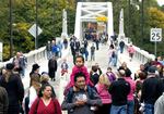 Pedestrians cross the Arch Bridge in Oregon City on Oct. 13, 2012.