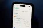 A phone displays crypto trades on Kalshi on Thursday, April 16, 2026, in Portland, Ore.
