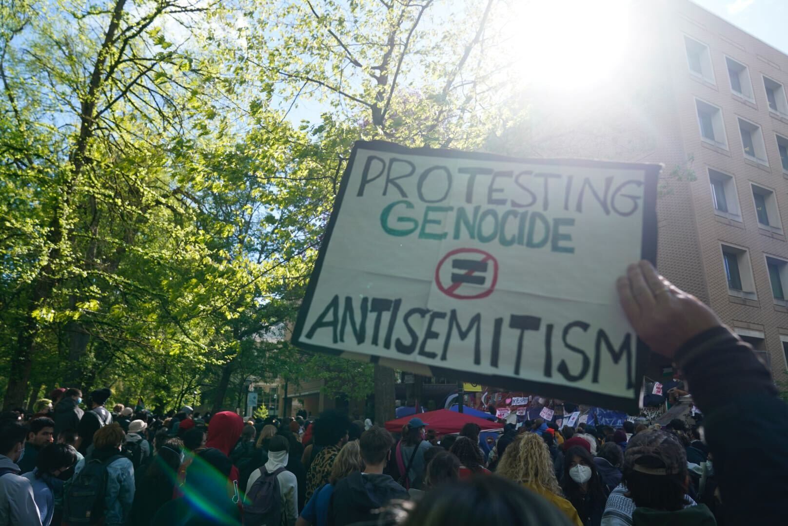 Hundreds of people attend a pro-Palestinian protest on Portland State University's campus on April 29, 2024. A protester is holding a placard that reads 