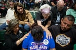 Community members prayed together at the vigil for the death of 19 students and two adults during the mass shooting at Robb Elementary School on May 25, 2022.