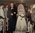A photo of Christopher Pelkey walking his sister Stacey Wales down the aisle at her wedding.