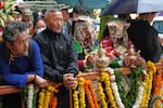 Devotees in their traditional dress wait for the arrival of Tibetan spiritual leader the Dalai Lama to attend an event celebrating his 90th birthday in Dharamshala, India, Sunday.