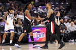 Portland Trail Blazers guard Ja Morant, left, and Portland Trail Blazers guard Damian Lillard, right, shake hands during the second half of a preseason NBA basketball game against the Sacramento Kings Tuesday, Oct. 13, 2026, in Sacramento, Calif.