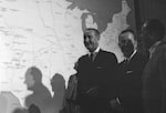 President Lyndon Johnson stands near a map of the U.S. after signing several conservation bills into law in 1968.
