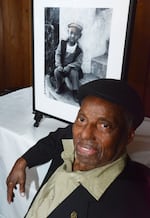 David Johnson in 2023 with one of his photographs, "Clarence," at an award luncheon at UC Berkeley honoring the photographer.