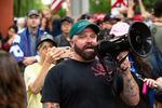 Joe Biggs, a member of the Proud Boys and former staffer at the conspiracy site Infowars, speaks to white supremacist demonstrators in Portland, Ore., Saturday, Aug. 17, 2019. Biggs organized the rally to "end antifa," referencing antifascist protesters who often show up to counter white supremacist groups in Portland.