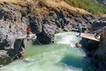 Fishers dipnet for salmon in the Klickitat River at Lyle Falls in Washington, Aug. 27, 2021. The fishing area is open only to members of the Yakama Nation and those who fish here say it is the only place similar to the type of fishing that existed at Celilo Falls on the Columbia which was flooded when the Dalles Dam was built.