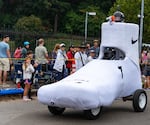 The Nike Design soapbox team rolls across the finish line with speed, finishing in second.
