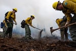 A group of wildland firefighting trainees work to mop-up a controlled burn during the annual five-day Mid-Willamette Valley Interagency Wildland Fire School, hosted by the Oregon Department of Forestry, in Sweet Home, Ore., on June 26, 2026. About 200 wildland firefighters and instructors participated in the training.