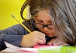 FILE -- In this file photo taken Oct. 2, 2014, fifth grader Claudia Starnes works on a project in her classroom at John Hay Elementary school in Seattle. The Washington State Supreme Court decision to hold the Legislature in contempt over lack of education funding is among the stop Washington stories of 2014.