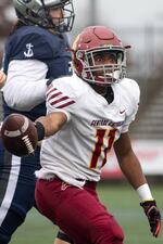 Central Catholic running back Elijah Elliott (11) gets up after securing the first down. The Central Catholic Rams played the Lake Oswego Lakers at Hillsboro Stadium in Hillsboro, Oregon, on Dec. 7, 2019. The Rams defeated the Lakers 49-28.