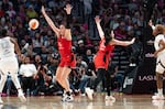 FILE — Las Vegas Aces guard Chelsea Gray (12) passes the ball to the inside of the paint as Portland Fire forward Bridget Carleton (6) attempts to block the ball at the Moda Center in Portland, Ore., on July 9, 2026. The Portland Fire played the Las Vegas Aces, loosing 88-80.