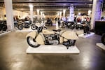 A custom motorcycle sits atop a white display platform at the One Motorcycle Show in Portland, Ore., Friday, Feb. 7, 2020.