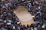 Los Angeles: Demonstrators deploy a giant banner reading "We the People," the first three words of the U.S. Constitution's preamble.