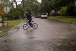 A person rides a bicycle in St. Petersburg, Fla., before Hurricane Ian hits the area on September 28, 2022.