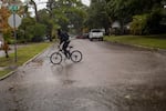 A person rides a bicycle in St. Petersburg, Fla., before Hurricane Ian hits the area on September 28, 2022.