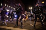 FILE - In this Nov. 4, 2020, file photo, police form a perimeter during protests following the Nov. 3 presidential election in Portland, Ore. A lawsuit alleging that law enforcement agents sent by President Donald Trump to protect a federal courthouse in 2020 used excessive force against racial justice protesters has been settled, the American Civil Liberties Union of Oregon said Tuesday.