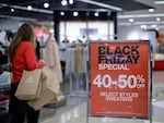 A shopper browses Black Friday sales at a Macy's store in Jersey City, N.J.