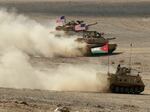 A Jordanian armored personnel carrier and U.S. tanks take part in the "Eager Lion" multinational military exercises in Jordan in September 2022. The U.S., Jordan and 28 partner nations took part in the exercises, representing one of the largest military exercises in the region.