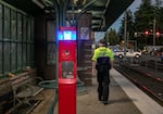 Transit Security Officer Benjamin Klopp patrols the platform at East 148th Avenue in East Portland, Ore., Sept. 22, 2025. The area around this station has had issues with gun violence and drug use, leading to safety concerns for those waiting at the platform. 