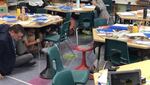 Eugene 4J Schools Supt. Andy Dey (left) joins fourth-graders in teacher Mary Kuhl's class in today's "Great Shakeout" by taking cover under desks, tables, and chairs during the brief exercise.