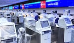 Flight check-in kiosks are seen covered in protective plastic at a deserted United Airlines check-in counter at Orlando International Airport ahead of the arrival of Hurricane Milton, on October 9, 2024 in Orlando, Florida. Milton is projected to make landfall as a Category 4 storm on Florida's Gulf Coast on Wednesday night or early Thursday morning. The airport ceased operations at 8:00 a.m. Wednesday.