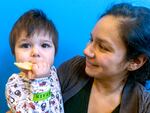 Thirteen-month-old Theo noshes a sugar cookie with his mom Ana Carteño at a toddler holiday party in Bend on Dec. 18, 2024.