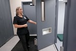 Chelsea Jones, of Adapt Integrated Health Care, opens the door to a stimulation room at a sobering center in Roseburg, Ore. on Sept. 16, 2024. The sobering center opened in 2021 and often functions as a holding cell.