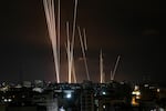 A salvo of rockets is fired by Palestinian militants from Gaza City toward Israel.