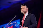 Jack Posobiec stands behind a lectern equipped with a microphone as he speaks at the Conservative Political Action Conference in February.