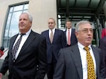 Former Luzerne County Court Judges Michael Conahan, front left, and Mark Ciavarella, front right, leave the United States District Courthouse in Scranton, Pa., in 2009. The two Pennsylvania judges who orchestrated a scheme to send children to for-profit jails in exchange for kickbacks were ordered to pay more than $200 million to hundreds of children who fell victim to their crimes.