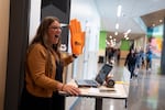 Beaverton High teacher Kellie Rosenberger greets students navigating the halls of their new high school.