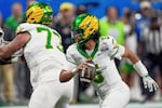 FILE - Oregon quarterback Dante Moore (5) works against Indiana during the second half of the Peach Bowl NCAA college football playoff semifinal, Jan. 9, 2026, in Atlanta.