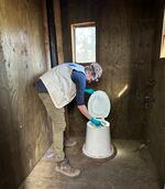 EIS officer Dr. Arran Hamlet swabs a backcountry pit latrine for norovirus sampling during an investigation for an outbreak of gastrointestinal illness among Pacific Crest Trail Hikers in 2022.