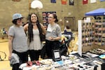 Angel TwoBulls, left, Leah Altman, center, and Chenoa Landry, right, at the Native American Youth and Family Center's Spring Marketplace.