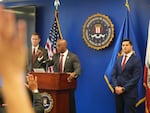 Akil Davis, Assistant Director in Charge of the FBI's Los Angeles Field Office, at podium, answers questions on the arrest of a Washington state man accused of providing chemicals used in last month's bombing during a news conference in Los Angeles, on Wednesday, June 4, 2025. At right, U.S. Attorney Bill Essayli.