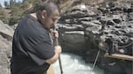 James Kiona Jr. uses a dip net to fish for salmon on one of the scaffolds at Lyle Falls.