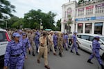 Security personnel patrol ahead of a tricolor (Indian flag) waving protest called by the youth “Cockroach” movement demanding the resignation of India’s election chief in central New Delhi, India, Friday, Oct. 16, 2026.