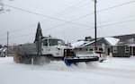 A snowplow clears eastbound Rosa Parks Way towards Vancouver Blvd., Portland, Feb 13, 2021. Snow and ice from the recent storm has made for hazardous driving conditions in the Portland metro area.